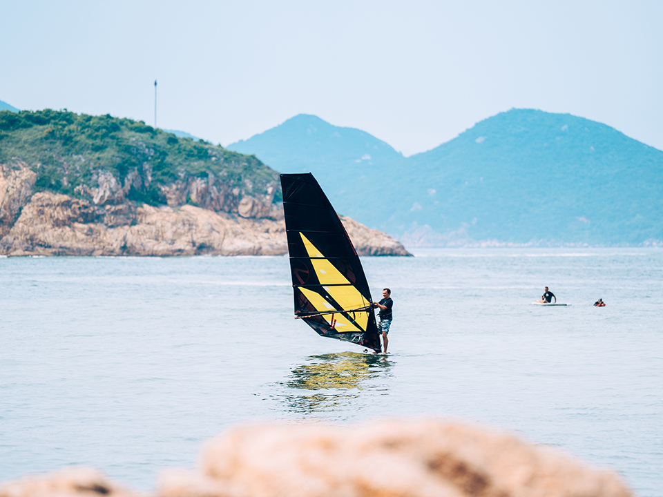 Surfers enjoying outdoor activities on Cheung Chau's calm beaches