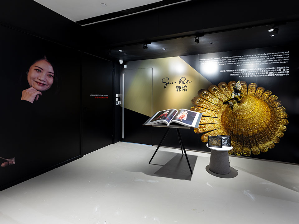 A curated fashion exhibition space showcasing iconic fashion pieces and design collections, featuring display cases that invite visitors to explore the world of fashion design.