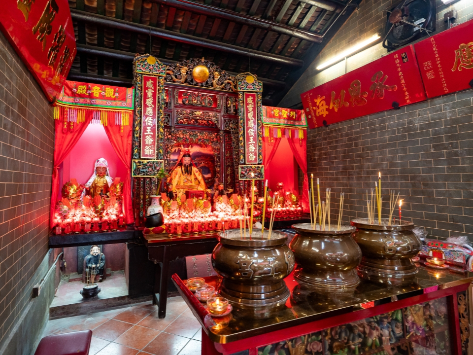 Altar with burning incense inside the Hau Wong Temple.
