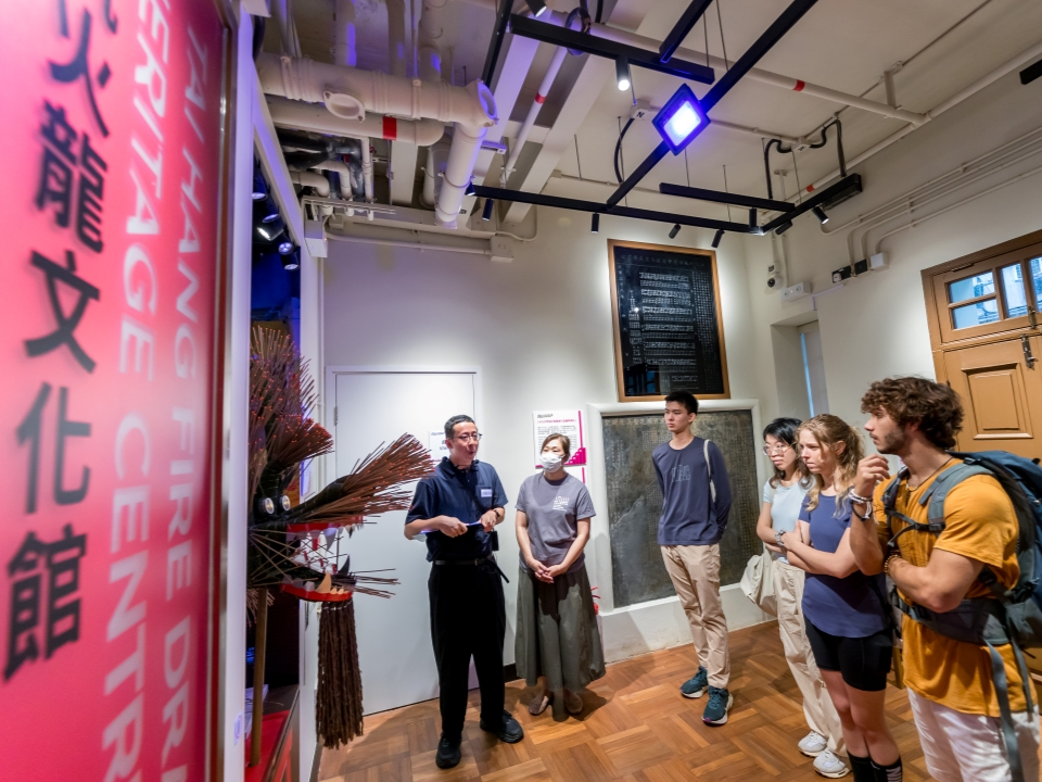  A group of people participating in a guided tour at the Tai Hang Fire Dragon Heritage Centre.