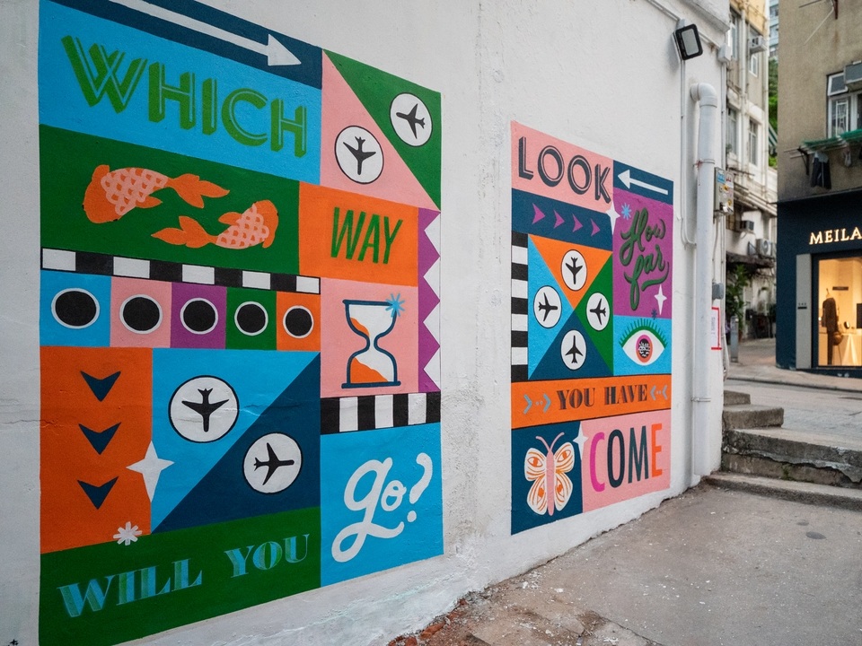 A colourful mural on a white wall by Erin Hung. 