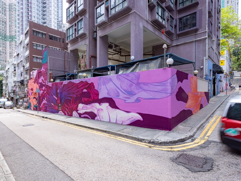 An intersection of Square Street and Tank Lane with a large pink and purple floral mural by George Rose. 