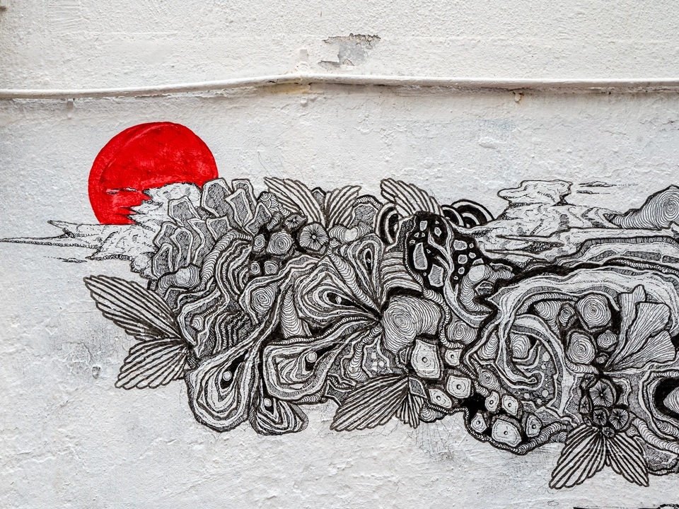 Detailed black and white flowing lines on an art mural by Joe Ellul on Tai Ping Shan Street. 