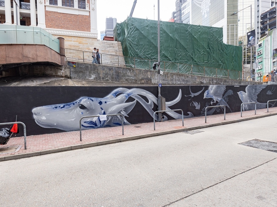 Long art mural against a wall by Nut on Wyndham Street. 