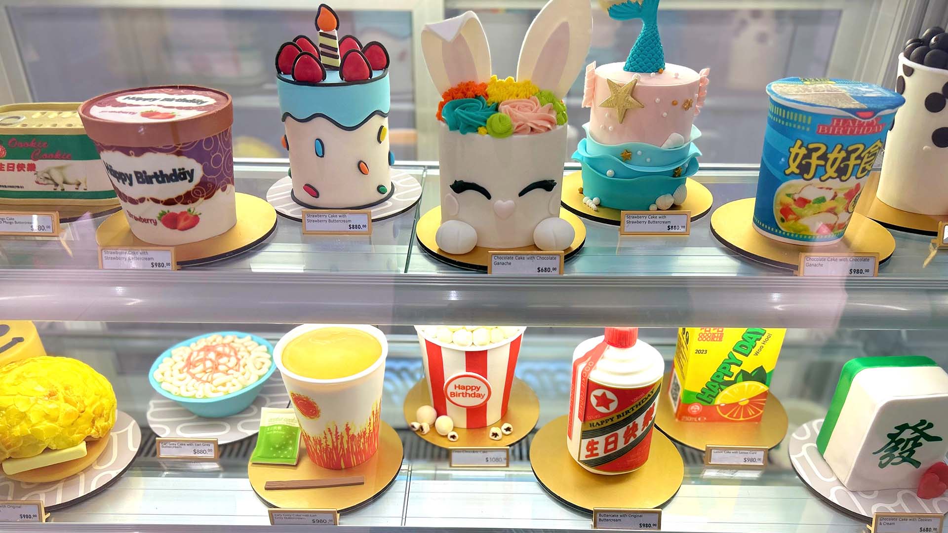 A display of colourful and creative cakes with different designs, decorations and shapes.