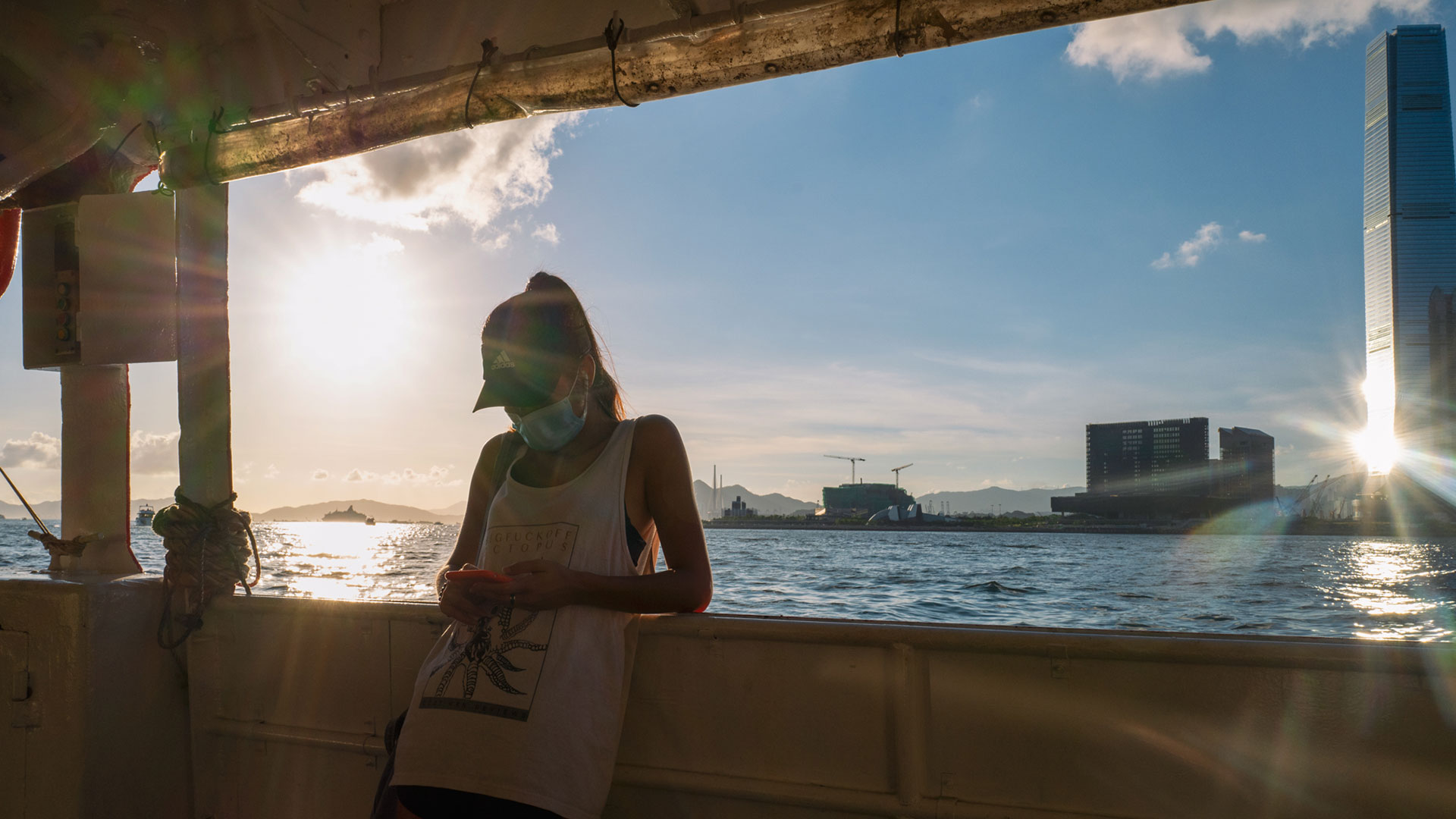 A woman taking the ferry under the sunset