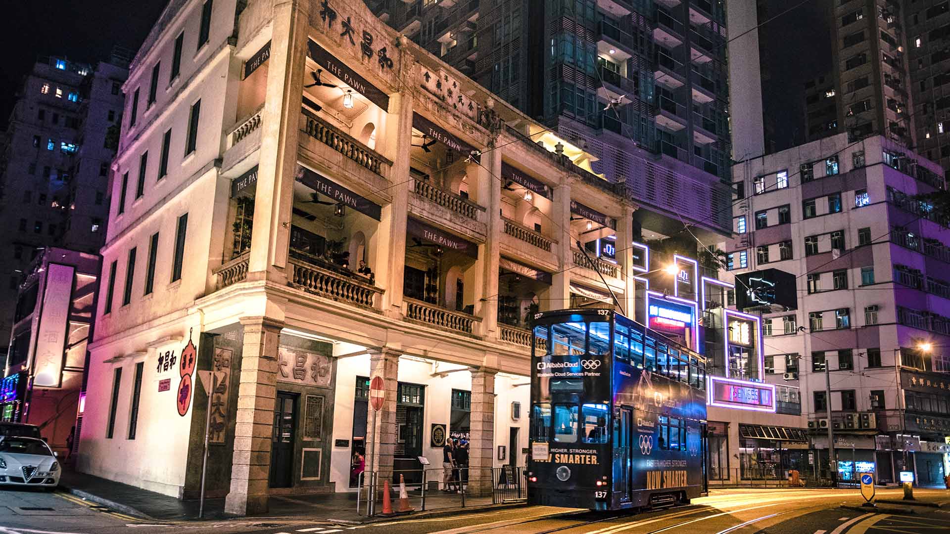 A tram passing by the Woo Cheong Pawn Shop in Wan Chai