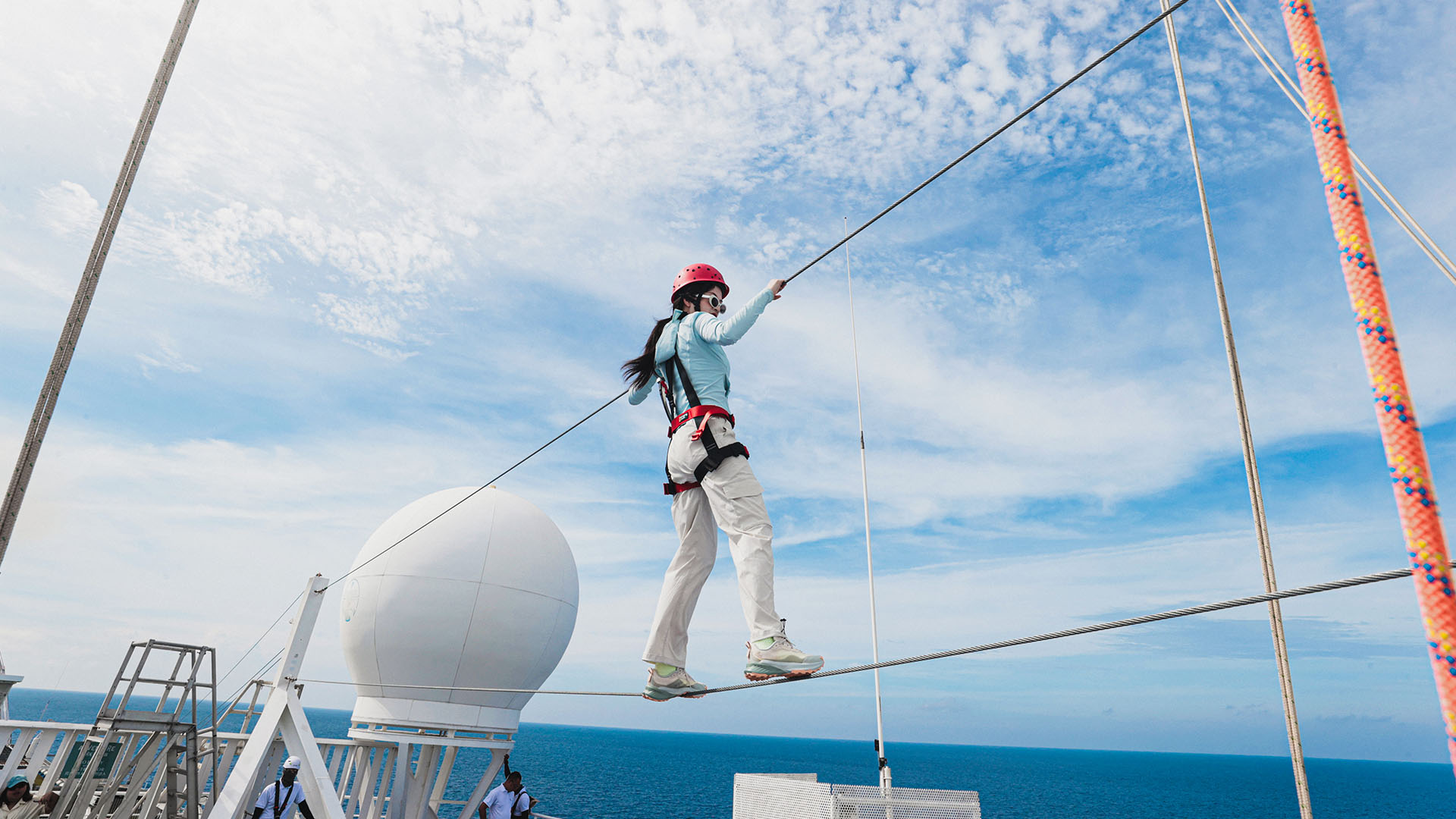 A person walking on a rope  aboard the Star Voyager.