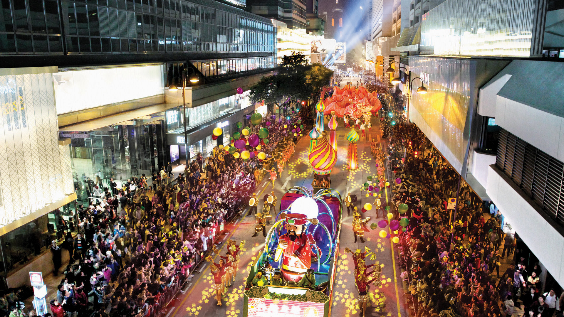 Crowds of spectators watching the Chinese New Year parade on the streets of Tsim Sha Tsui