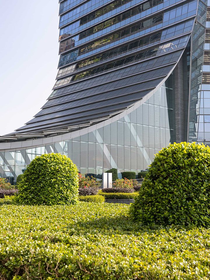 The ICC tower tapers down to a curved canopy at its base like a dragon’s tail