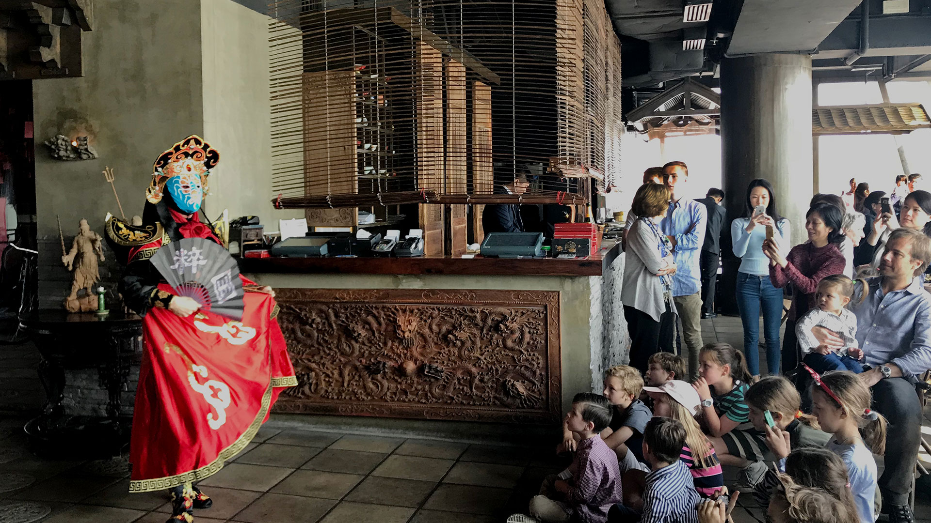 People enjoying Chinese Opera