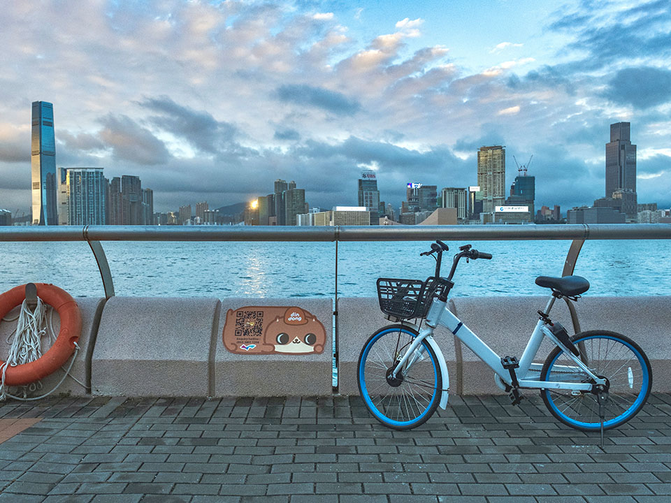 A gentle breeze can be felt along the Central Promenade as visitors ride a free shared bike.