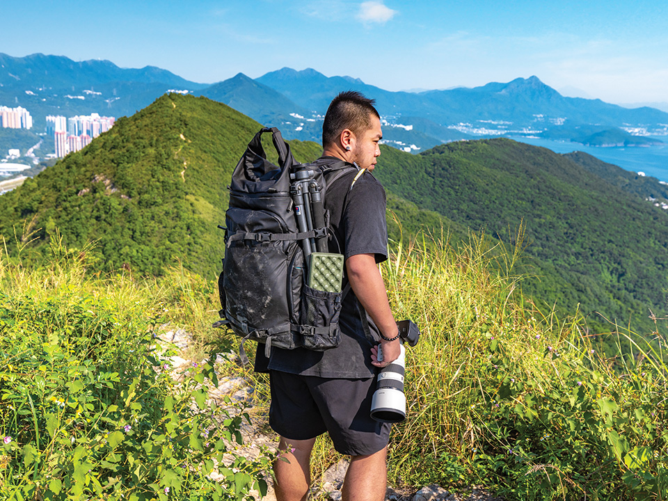 Vincent Chan often carries heavy photographic equipment with him up to the mountains