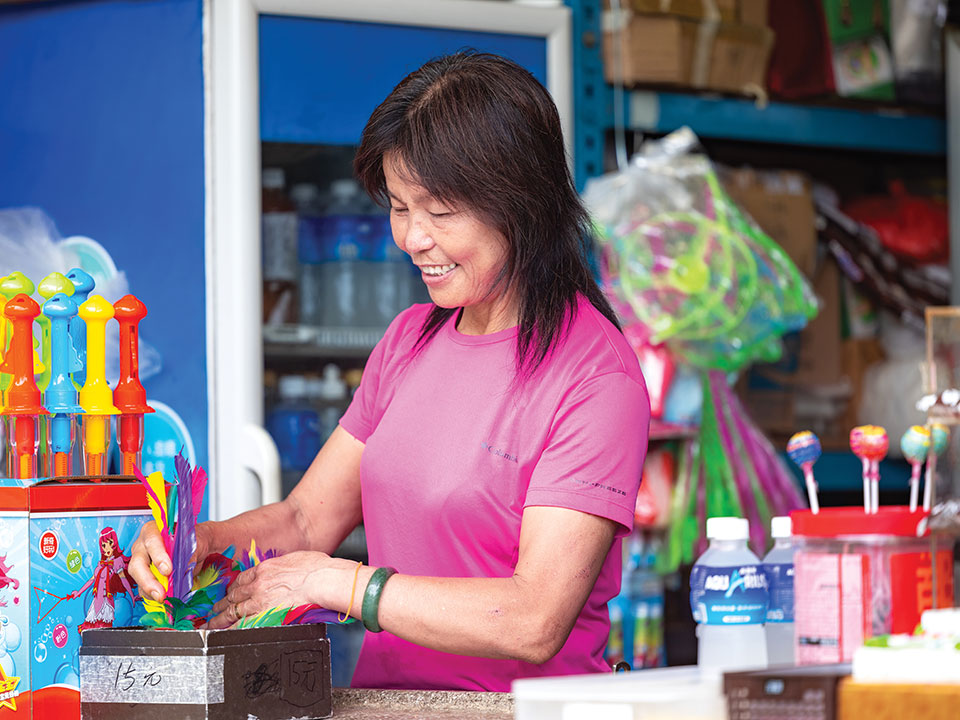 Lin Jei refilling shuttlecocks, one of many goods for sale at Tai Mo Shan Refreshment Kiosk