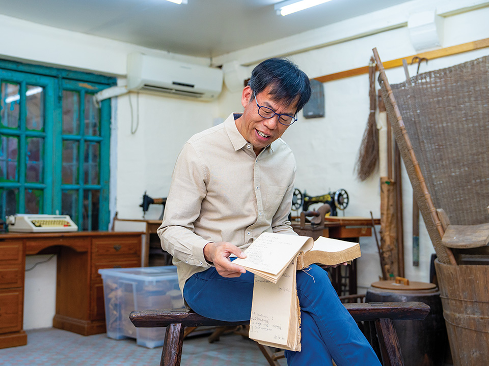 Lee in his story house, explaining the precious exhibits such as a half-century old ledger.