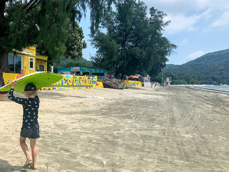 Kid holding a surf board