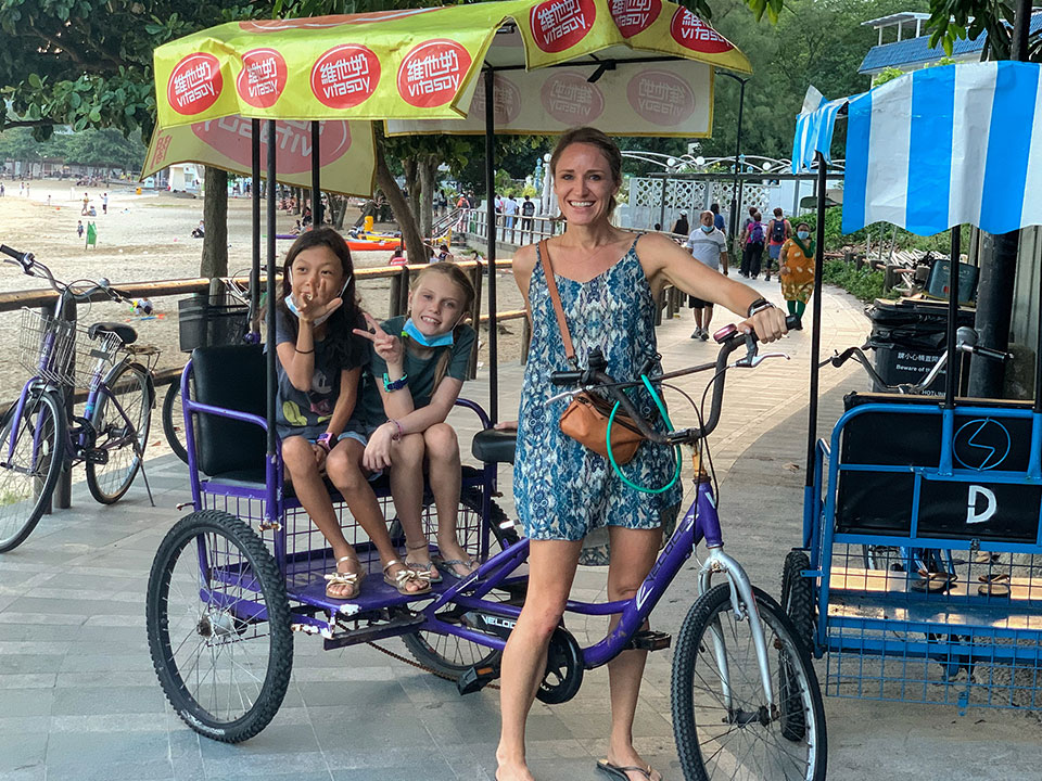 Three people with surrey bike for four