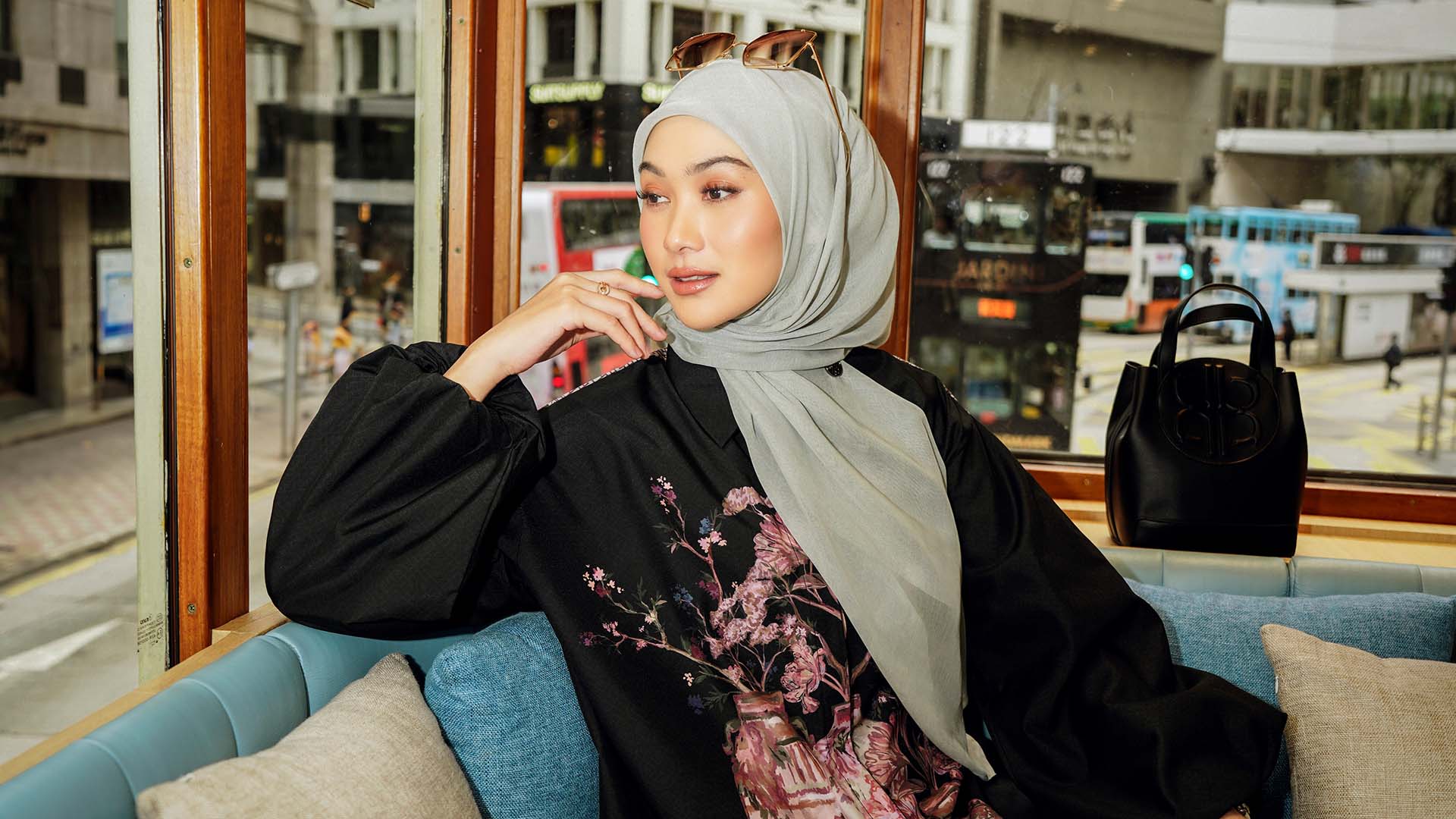 Indah Nada Puspita in a red outfit holding a red umbrella.