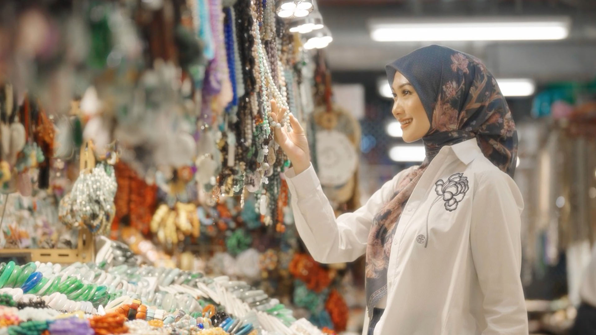 Indah Nada Puspita looking at beaded necklaces at the Yau Ma Tei Jade Market.