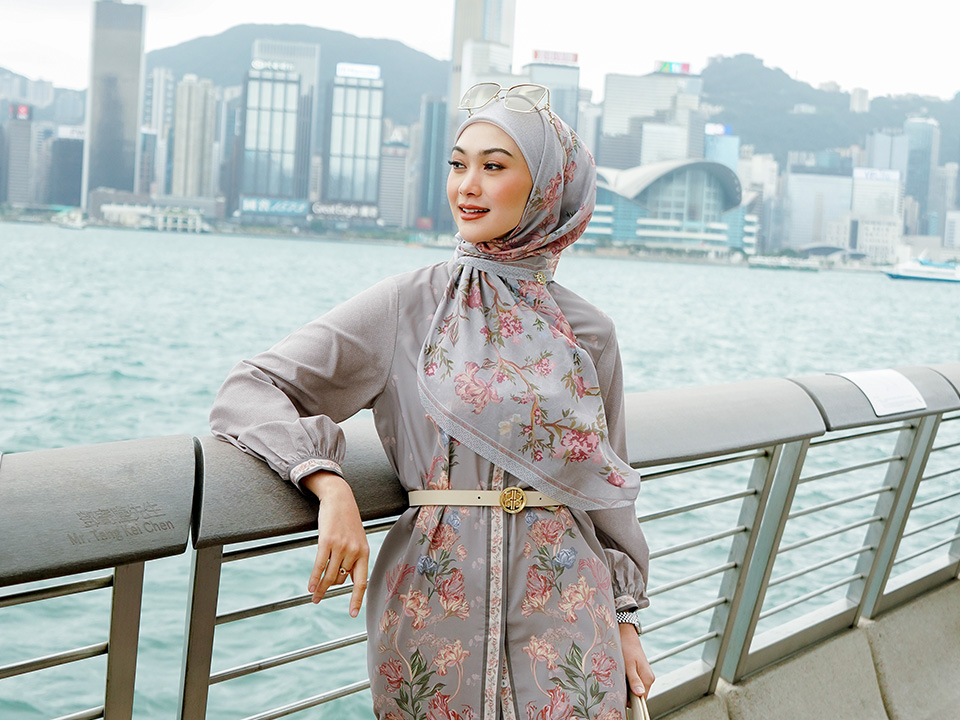 Indah Nada Puspita in front of the Hong Kong skyline in Tsim Sha Tsui.