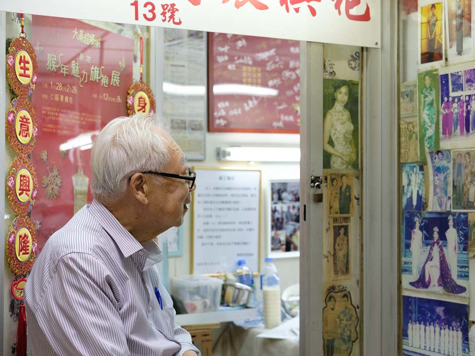 Master Yan looking at old photographs of his work