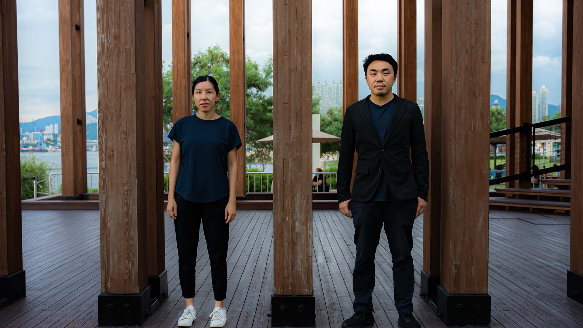 Architects Evelyn Ting (left) and Paul Tse (right) standing in the ’Growing Up’ Pavilion