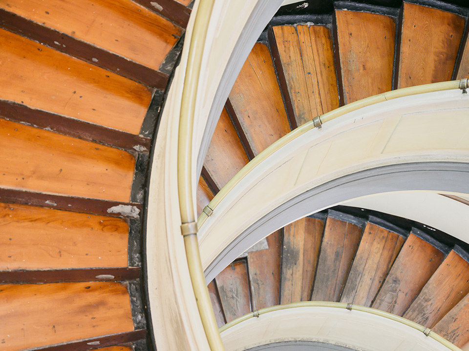 The intricate wooden spiral staircase inside the Western District Community Centre