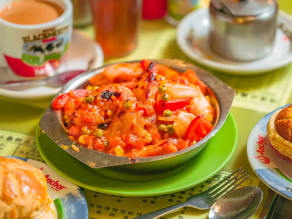 Hong Kong’s dining scene offers famous dishes like noodles and char siu pork. Cha chaan tengs serve comfort food like baked pork chop rice and Hong Kong milk tea.