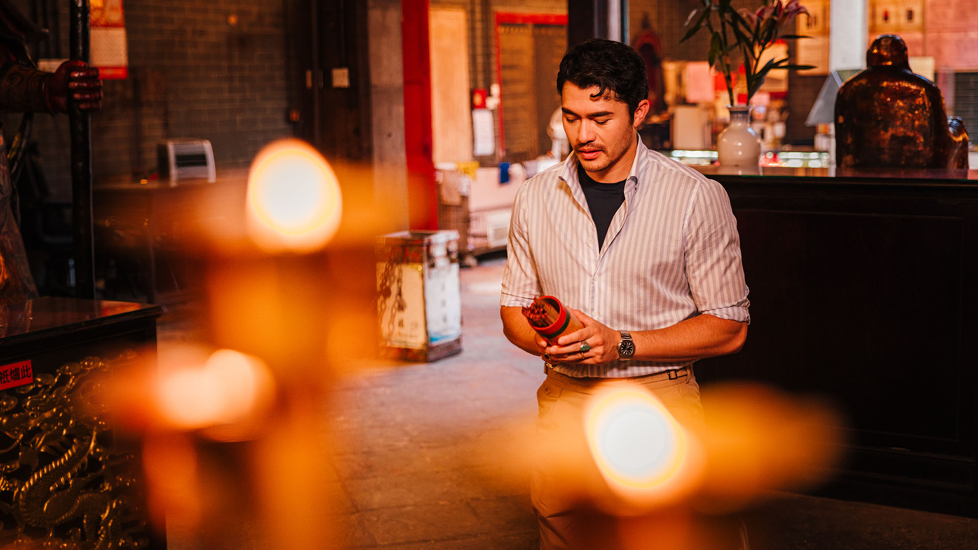 Henry Golding drawing a fortune stick at Tin Hau Temple